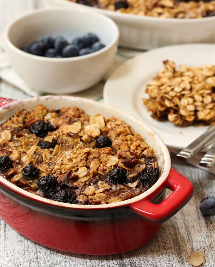 Baked berry coconut oatmeal in a rustic dish with blueberries and oats, a healthy diabetes-friendly breakfast casserole.
